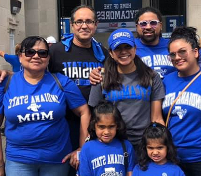 Family wearing ISU blue shirts outside